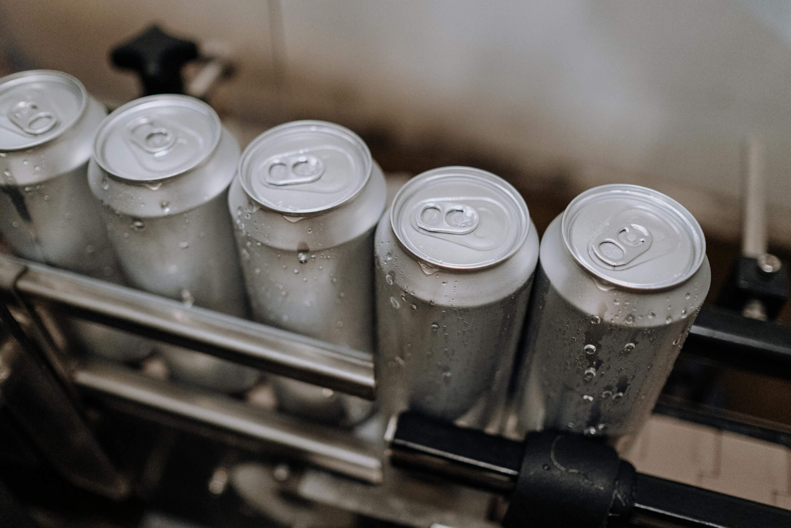 several drink cans processed in our production facility scaled